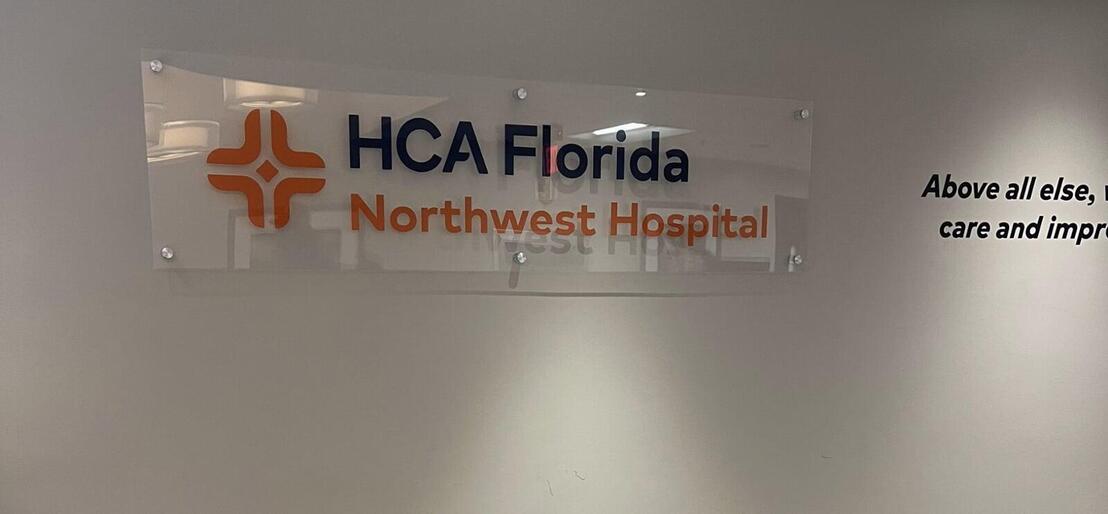 HCA Florida NW Hospital sign on a wall in the hospital