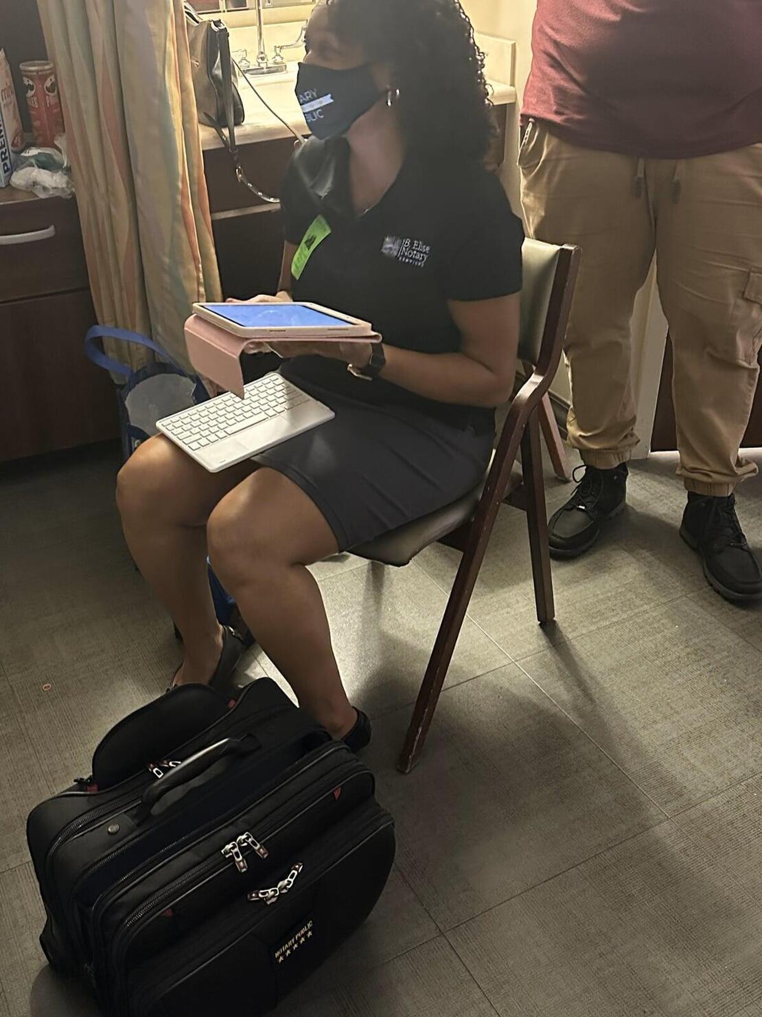B. Elise notary sitting in a hospital room
